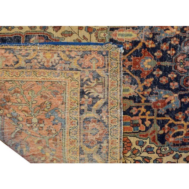 An amazing early 20th century Persian Sarouk Farahan rug with a large central medallion composed of multiple flowers woven...