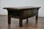 A Spanish oak coffee table from the early 19th century with two drawers and carved décor. This antique Spanish oak table,...