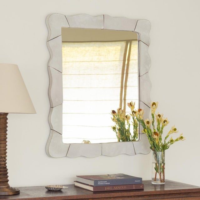 Wall mirror with wavy ceramic frame. Handmade by Morgan Peck. About the artist: Morgan Peck is a ceramicist living in Los...
