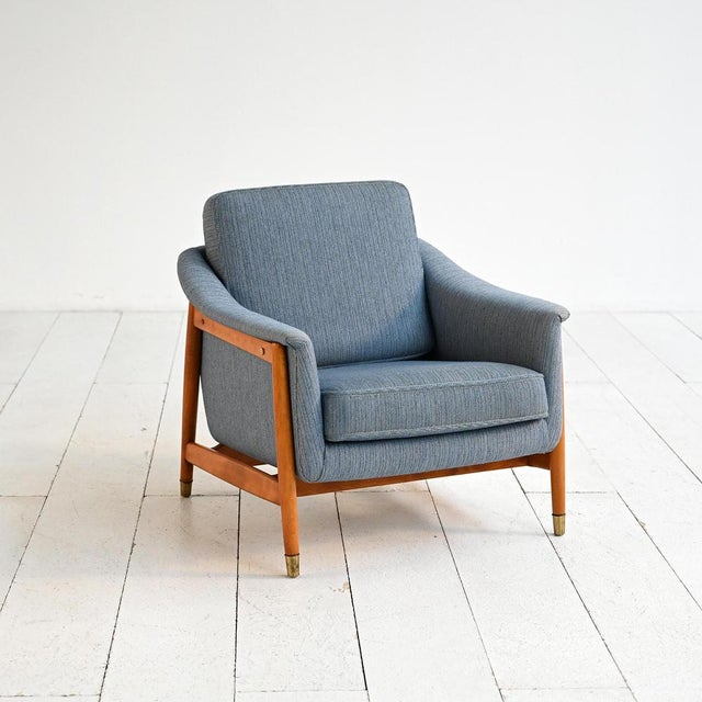 "Scania" armchair with a beech wood frame, brass tips, and fabric upholstery. Designed by Folke Ohlsson, produced by...
