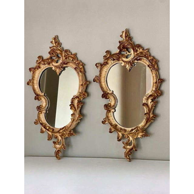 Great pair of 19th century Italian Rococo style cream painted and parcel giltwood mirrors. Crafted of both wood and...