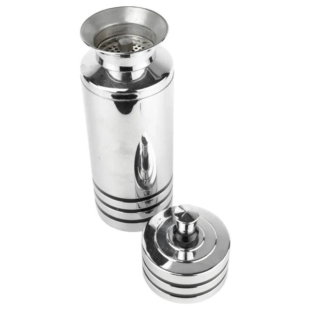 Period Art Deco cocktail shaker by Howard Reichenbach for Chase. Polished chrome with black stripe accents.