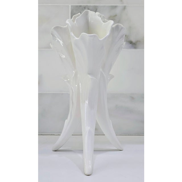 Bring a touch of sculptural drama to your space with this striking porcelain triple-horn bud vase. Crafted in a glossy...