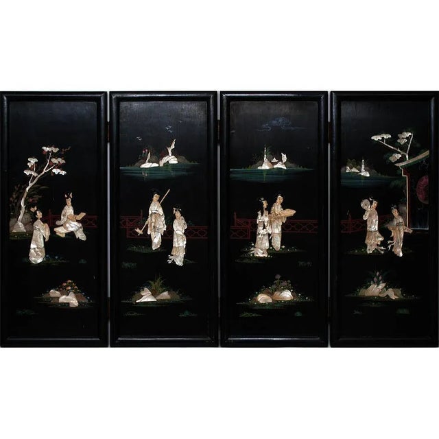 Fine Chinoiserie Coromandel 4-panel screen. Black lacquered wood, with bone, jade and mother-of-pearl inlay, depicting...