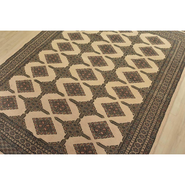 A tribal Bokhara Jaldar rug hand-knotted with fine wool on a cotton foundation. This rug features rows of repeating...