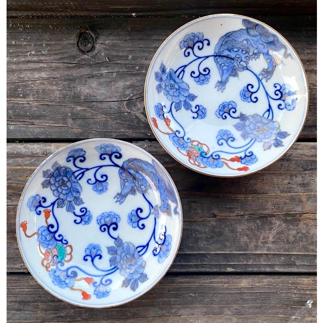 A charming pair of antique Japanese porcelain pedestal bowls executed in the refined Hirado style and decorated with...