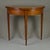 Neat card table in light Mahogany and all parts in original. Demi lune form. Foldable top with extendable middle back leg.