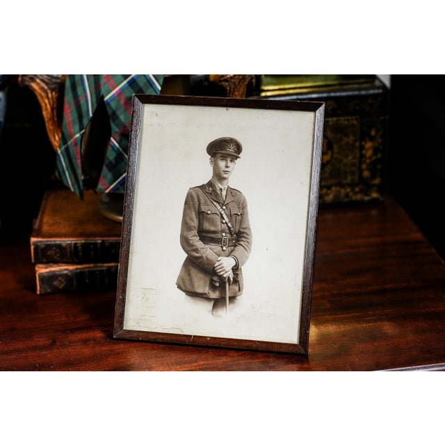 This World War I-era original photograph features a young soldier in uniform, posed in a formal, dignified stance. He is...