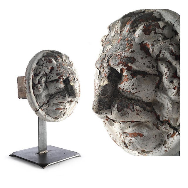 Belgian mascaron in terracotta lion-shaped head disposed on a foot of iron. Terracotta sculpture up used on old buildings...