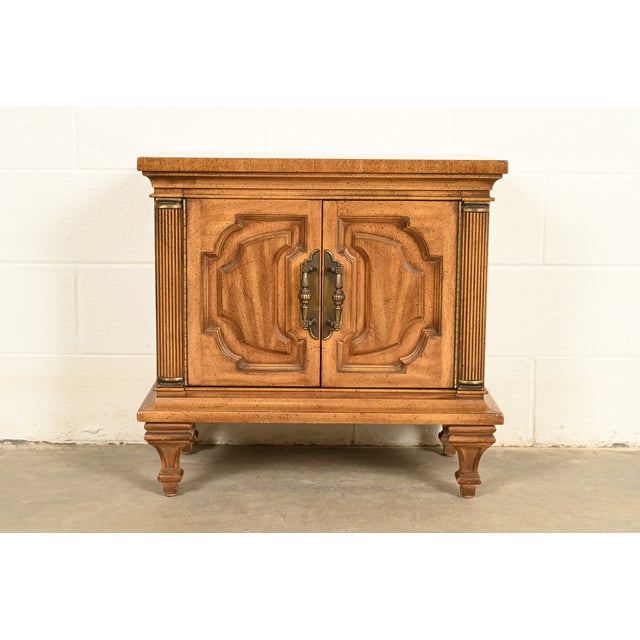 A gorgeous mid-century Hollywood Regency period bedside chest or nightstand In the manner of Karges Furniture Distributed...