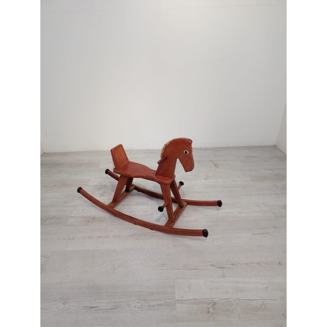 This classic wooden rocking horse is a timeless children's toy crafted in a retro/vintage style. It features a minimalist,...