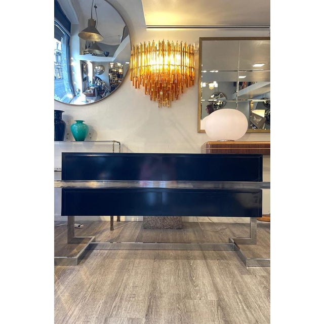 1960s chest of drawers in wood with a steel structure. It features four drawers, two in the upper section and two in the...