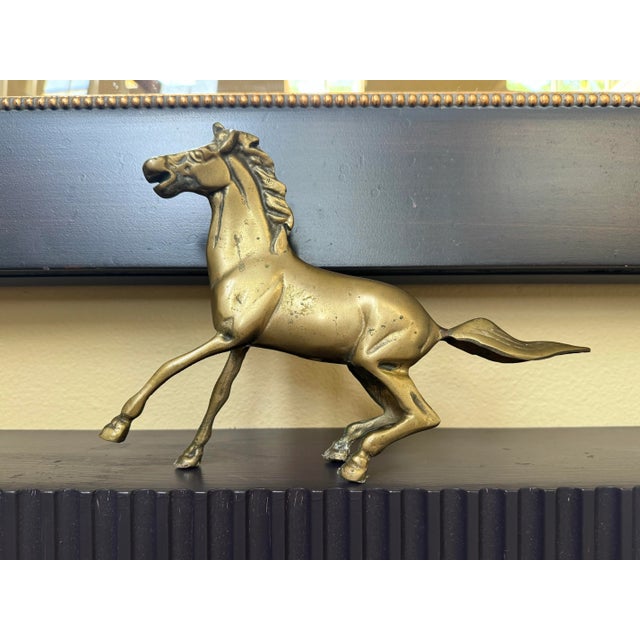 Etched in detail with a chiseled face, mane and consisting of solid brass this 'heavy breathing' galloping horse is sure...