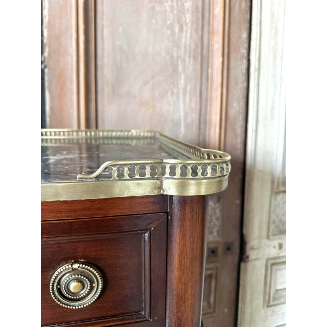 A louis xvi style mahogany and mahogany veneer chest of drawers, circa 1900. The drawers open with bronze ring handles....