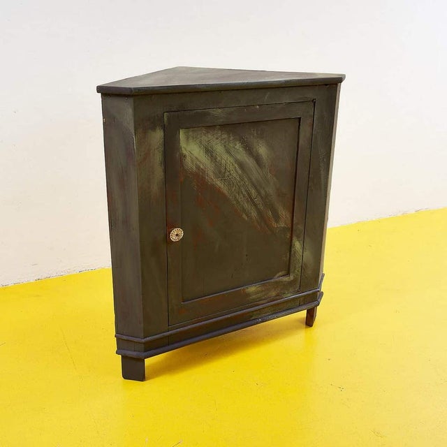 This corner sideboard is a charming example of practical, vintage design. Crafted from sturdy wood, it features an olive...