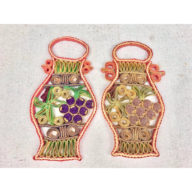 Vintage pair of raffia trivets. Grape design. Perfect to use as a decorative accent in a kitchen or as a trivet. These are...