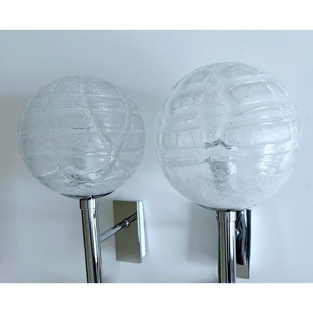 Pair of Vintage Space Age sconces by Doria 1970s, chrome brass structure with structured cocoon Murano glass globes...