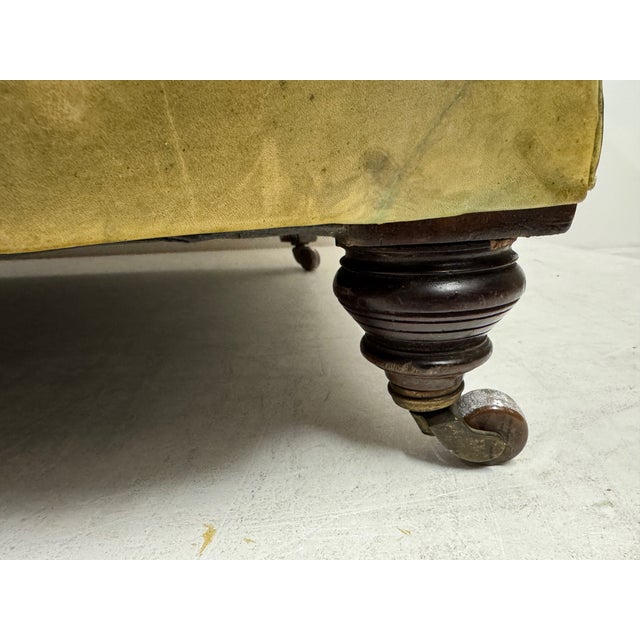 A classic late 19th century Chesterfield sofa, upholstered in richly patinated leather. The piece features the hallmark...