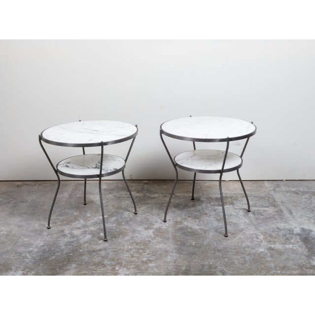 A pair of Italian steel side tables from the mid 20th century, with marble tops and shelves. Created in Italy during the...
