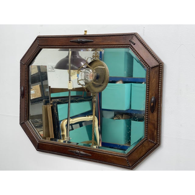 A finely crafted Arts and Crafts period wall mirror, dating to the early 20th century. featuring a solid quarter-sawn oak...