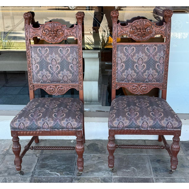 Design Plus Gallery presents a Pair of Renaissance Revival Dining Room Chairs. The have deep, highly detailed hand carving...