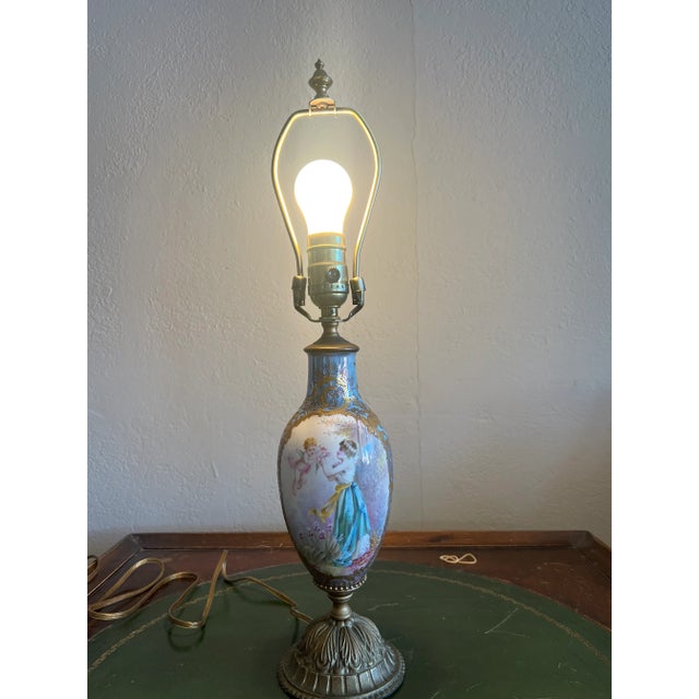 once a decorative piece in the 1900's, now a beautiful table lamp. Amazing craftmanship with delicately detailed painting...