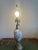 once a decorative piece in the 1900's, now a beautiful table lamp. Amazing craftmanship with delicately detailed painting...
