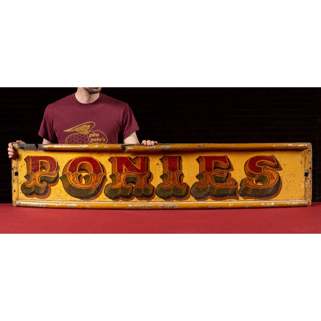 Antique hand-painted circus wagon panel. A vibrant wooden panel once part of a traveling circus wagon, featuring the word...