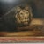 A compelling antique oil painting depicting a reclining lion. The composition favors atmosphere over drama, allowing the...