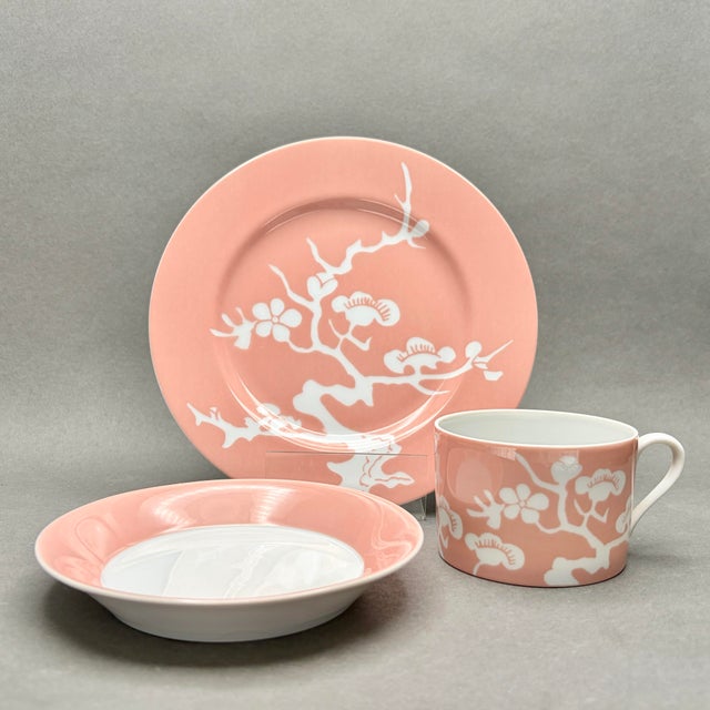 This elegant 18-piece vintage porcelain set by Fitz and Floyd features the striking MCMLXXVI (1976) “Plum Blossom” pattern...