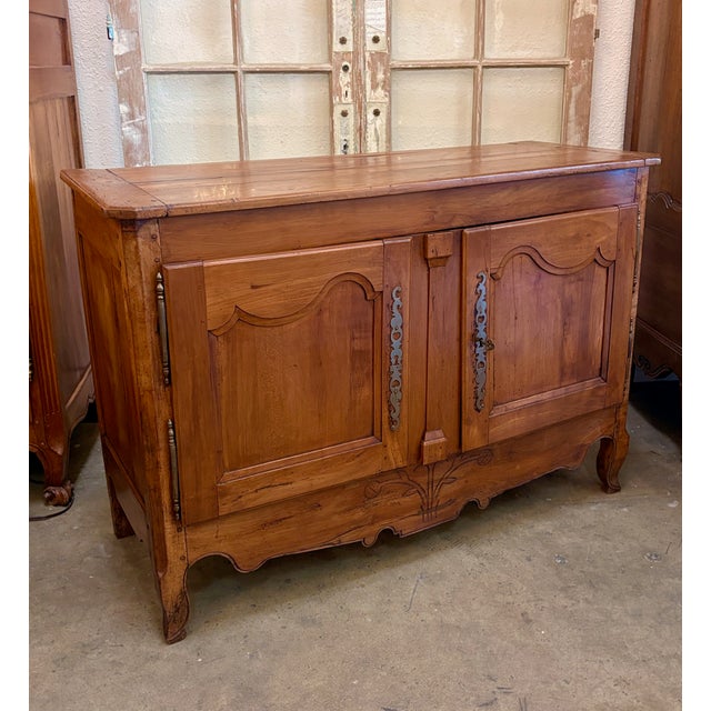 Early 19th century Country French Buffet, entirely hand-crafted from French cherry, and accented with iron hinges, hand...