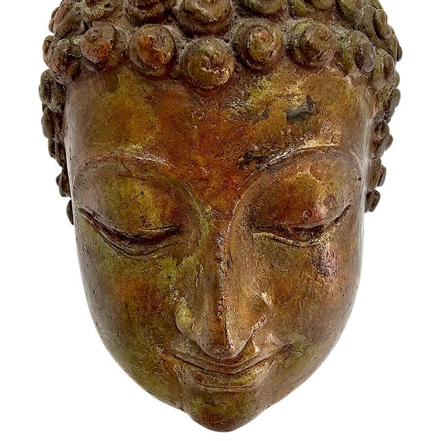 A twentieth-century Thai cast bronze Buddha head modelled in the classical Sukhothai tradition. The sculpture is formed as...