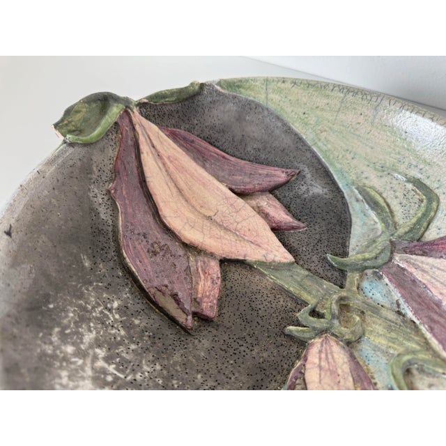 This charming vintage art pottery bowl is a captivating piece featuring a raised floral relief that beautifully extends...