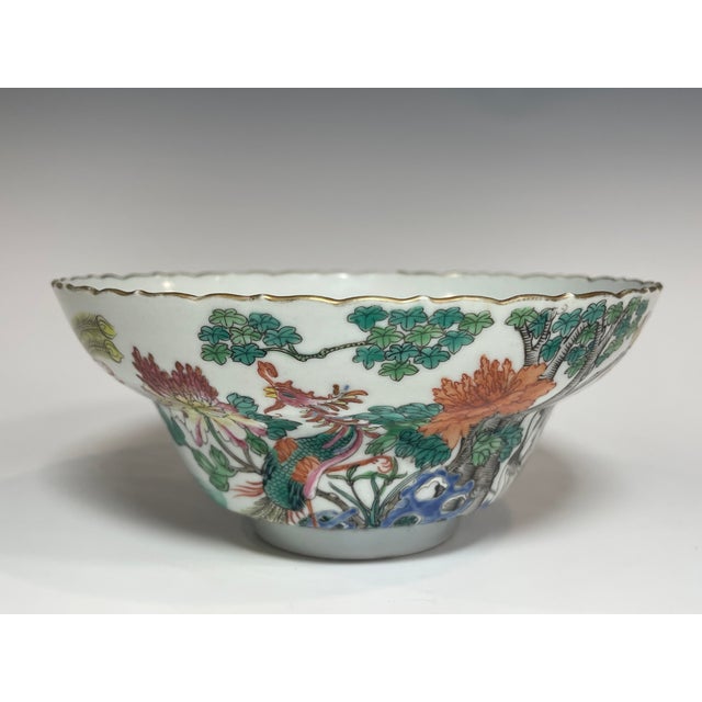 A stunning Chinese polychrome enamel (Famille Rose / Fencai) porcelain bowl featuring a scalloped foliate rim and rich,...