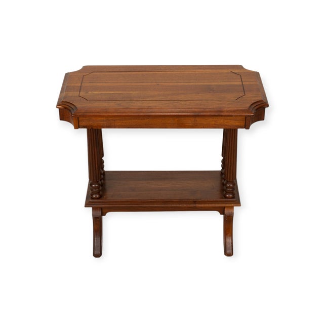 Walnut side table with six reeded column supports arranged in groups of three at either end. The rectangular top has...