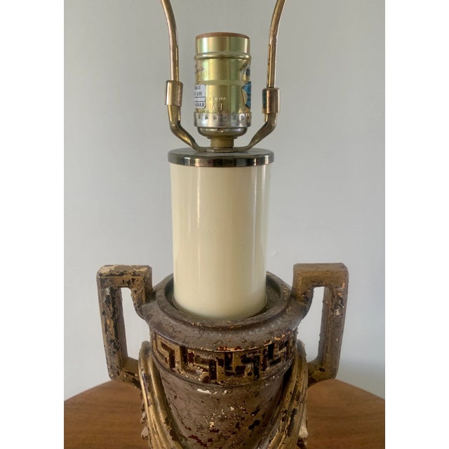 A handsome late 20th century Neoclassical table lamp in an urn-form silhouette, detailed with a Greek key border, squared...
