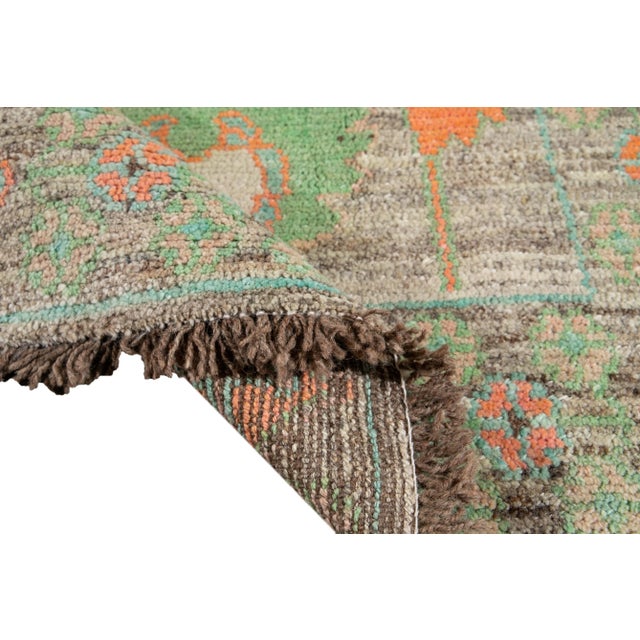 Beautiful Modern Oushak Turkish handmade Wool runner with a gray field. This Oushak runner has accents of pink, yellow,...