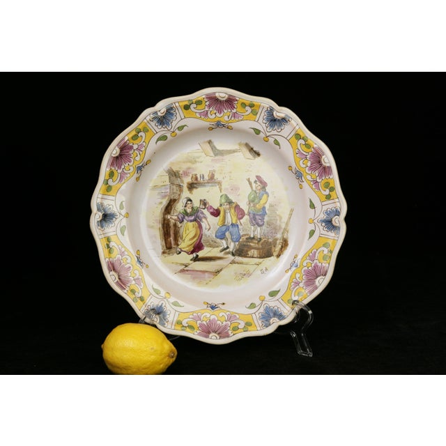 From the potteries of Lille France in the late 19th century, a transferware and hand-painted faience earthenware plate...