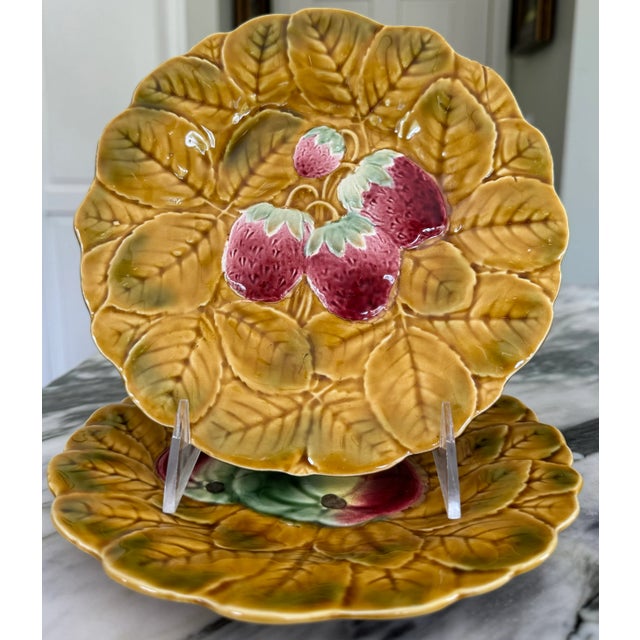 Presenting a pair of French majolica plates attributed to Sarreguemines. Order includes two fruit motif plates. They are...