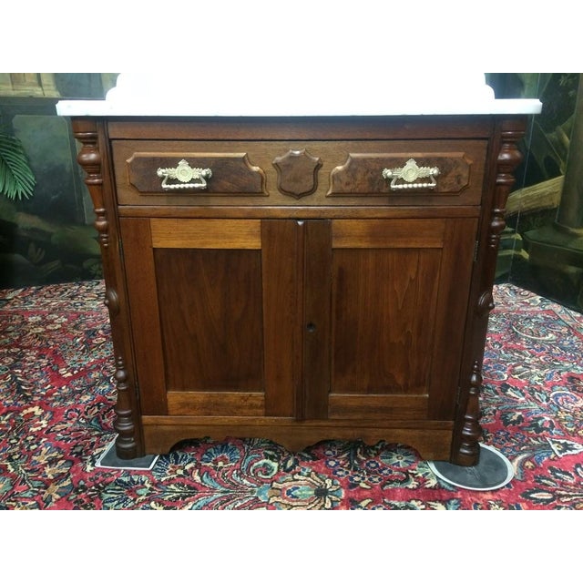 Item: Antique Walnut Washstand with Marble Top. Age & Condition: Circa 1880. Good, light stains on the marble. Lock...