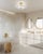 Glass takes center stage in this exquisite flush mount. The round shade is made of a thick piece of hand-blown piastra...