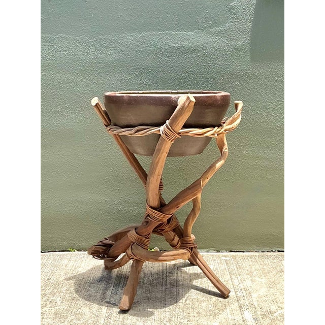 This vintage plant stand is a captivating fusion of organic form and functional mid-century design, crafted from twisted...