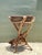 This vintage plant stand is a captivating fusion of organic form and functional mid-century design, crafted from twisted...