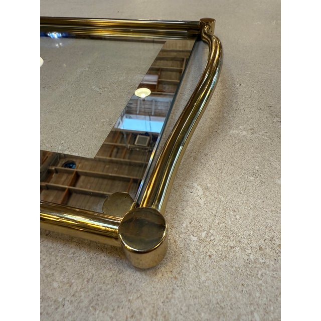 Elegant rectangular tray crafted in Italy during the 1970s, featuring a clear glass surface framed by polished brass...