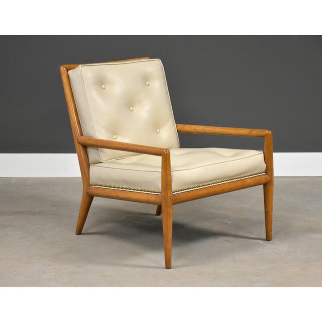 A mid century modern birch frame WWZ lounge chair with cream white vinyl upholstery designed by T.H. Robsjohn Gibbings for...