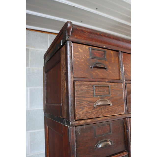 Early 20th-century sectional stocking file cabinet by Globe, crafted in quarter sawn oak with an impressive tall, stacked...