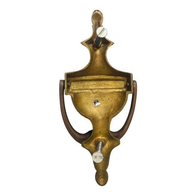 Traditional style door knocker in antique brass finish. Suitable for engraving. Marked India. Includes mounting screws.