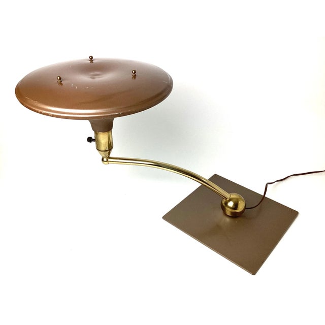 Art Deco 1930s Modern sight light table lamp. Brass with copper baked brown enamel shade and base. Arm swivels. Age...