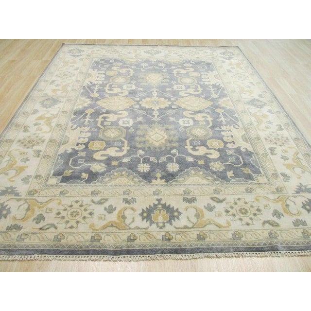 This blue wool area rug is a hand knotted pile floor covering featuring a classic traditional design. Modeled after the...