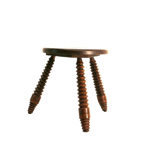 French three-legged stool made of turned wood, circa 1940, in the Dudouyt style, made entirely of solid wood with a...